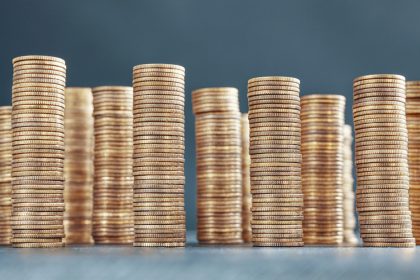 Stacks of golden coins, selective focus